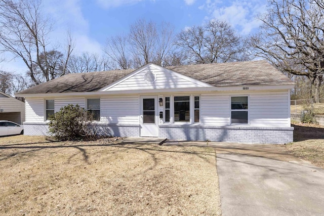 single story home featuring a front yard and brick siding