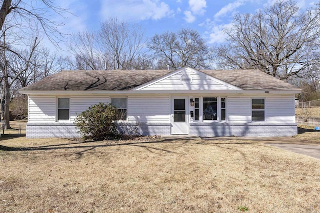 ranch-style home with a front yard and brick siding