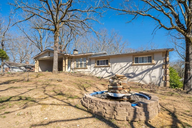 ranch-style home with a chimney