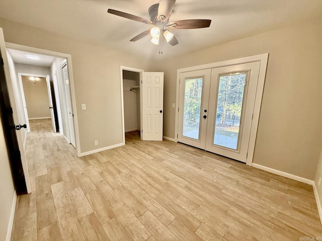 unfurnished bedroom with light wood-type flooring, access to exterior, baseboards, and french doors