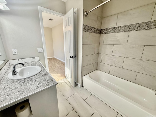 full bathroom featuring shower / bathing tub combination, vanity, visible vents, and baseboards