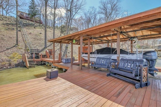 deck with a boat dock and boat lift