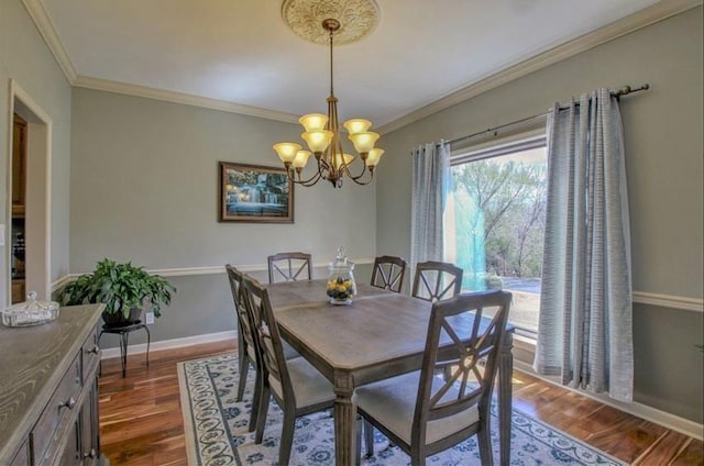 dining area featuring crown molding, a chandelier, dark wood finished floors, and baseboards