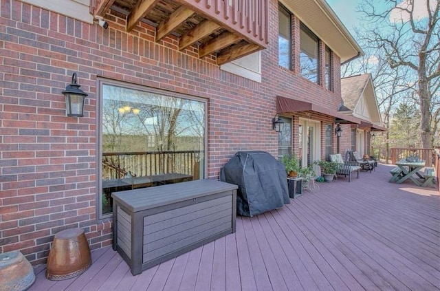 wooden deck featuring area for grilling