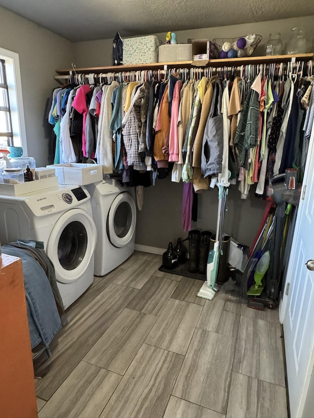 laundry room featuring wood finish floors, laundry area, and washing machine and clothes dryer