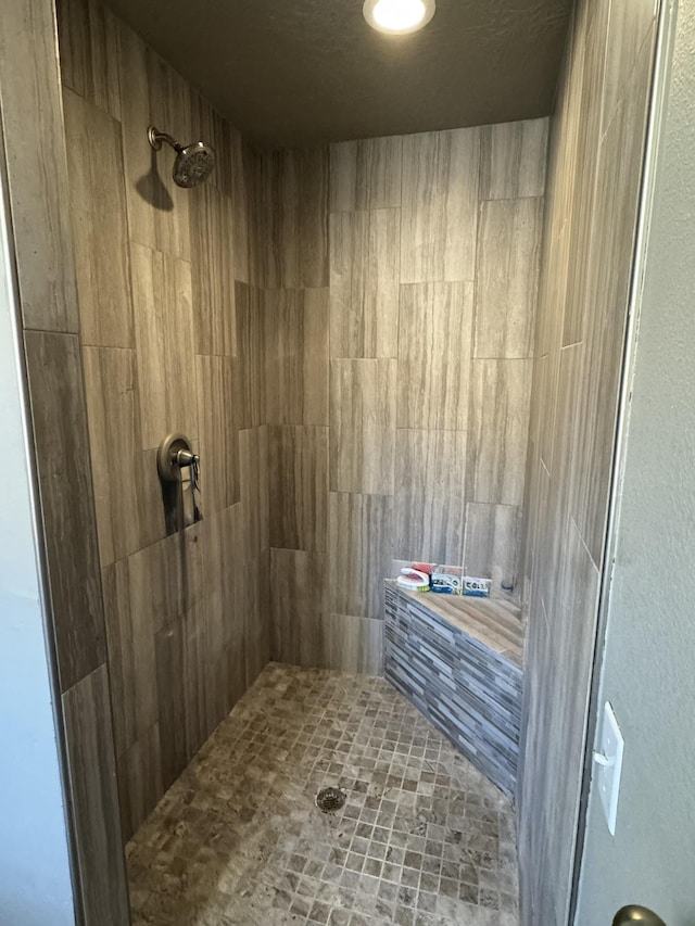 bathroom featuring tiled shower and a sauna