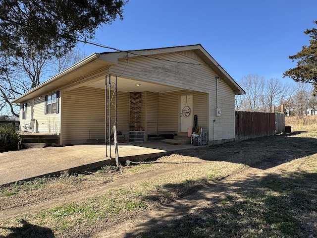 exterior space with entry steps, a patio area, and fence