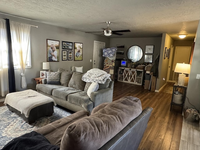 living room with a textured ceiling, ceiling fan, and wood finished floors