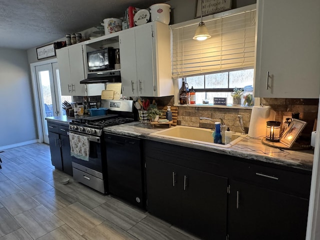 kitchen with dark cabinetry, a sink, under cabinet range hood, and black appliances