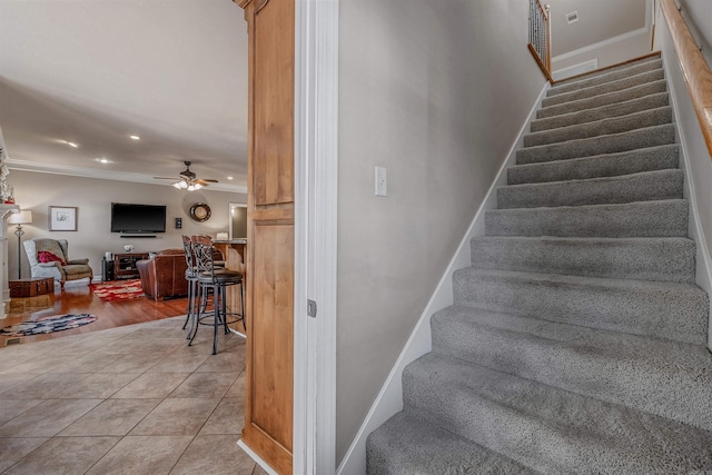 stairway featuring recessed lighting, a ceiling fan, ornamental molding, tile patterned flooring, and baseboards