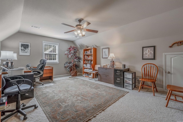 office space featuring vaulted ceiling, ceiling fan, carpet, and visible vents