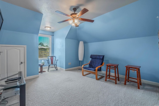 sitting room with lofted ceiling, baseboards, ceiling fan, and carpet