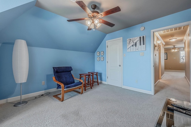 sitting room featuring lofted ceiling, carpet, baseboards, and a ceiling fan