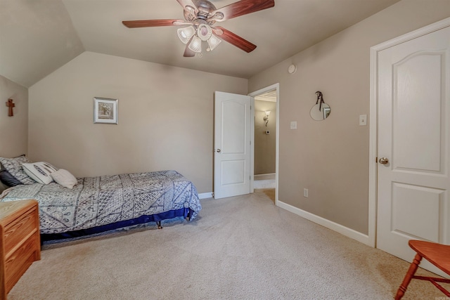 bedroom featuring light carpet, baseboards, vaulted ceiling, and a ceiling fan