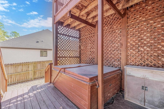 wooden deck featuring a hot tub