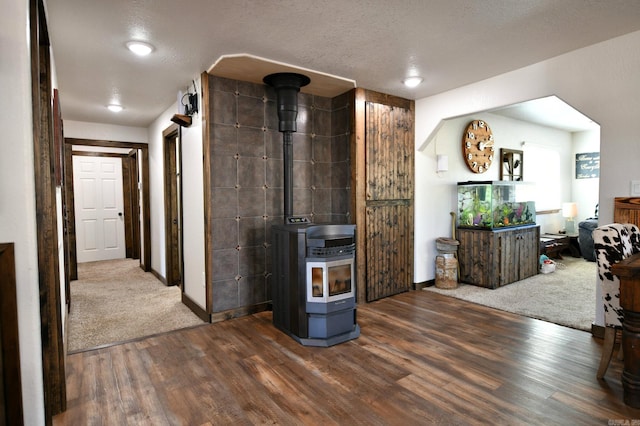 hallway with a textured ceiling and wood finished floors