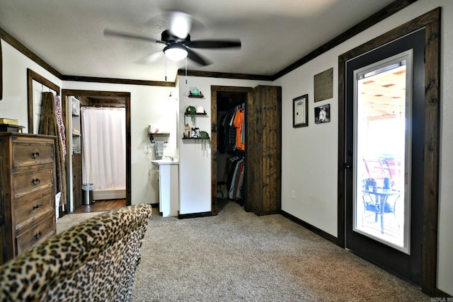 carpeted bedroom with ceiling fan, ornamental molding, and baseboards