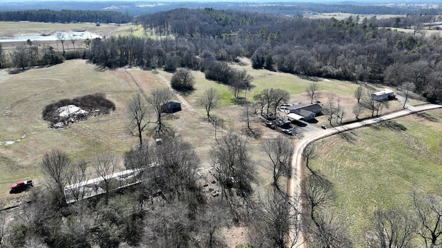 aerial view featuring a rural view and a wooded view