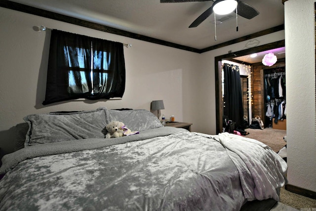 carpeted bedroom featuring ceiling fan and crown molding