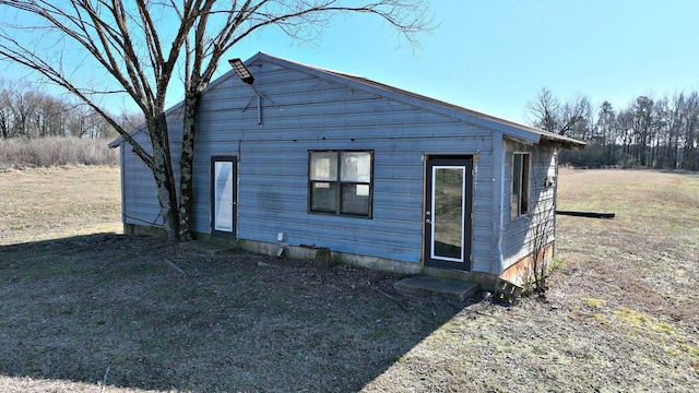 rear view of house featuring a lawn