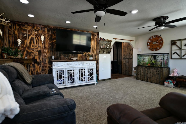 carpeted living area with a textured ceiling, a ceiling fan, and recessed lighting