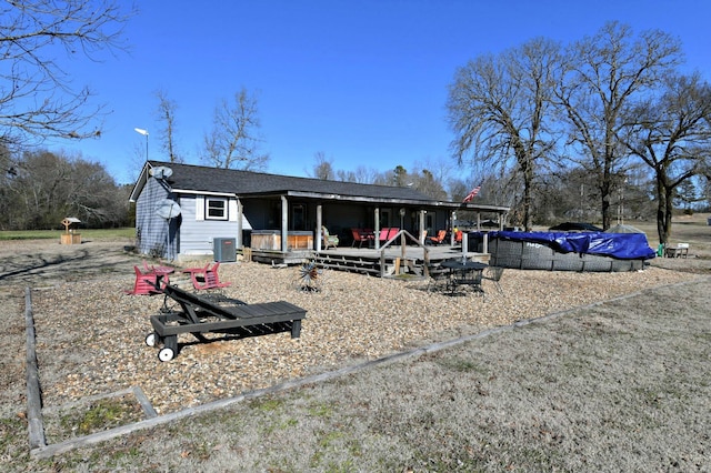 back of house featuring a shingled roof