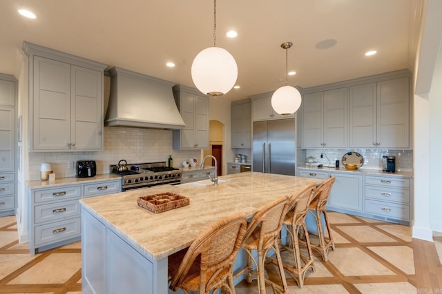 kitchen with gray cabinets, custom exhaust hood, high end appliances, and recessed lighting