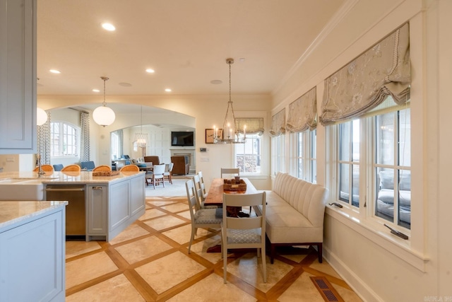 interior space with recessed lighting, visible vents, ornamental molding, a chandelier, and baseboards