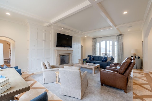 living area with baseboards, arched walkways, beam ceiling, and recessed lighting