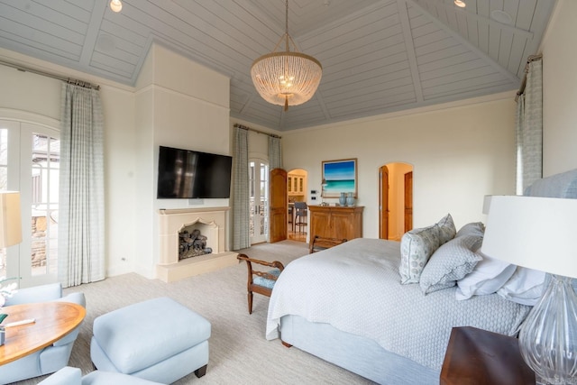 bedroom featuring arched walkways, a fireplace with raised hearth, high vaulted ceiling, wooden ceiling, and carpet