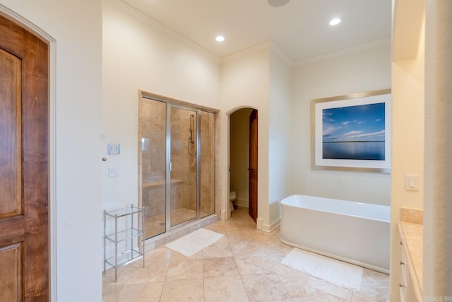 bathroom with a freestanding bath, a stall shower, toilet, and crown molding