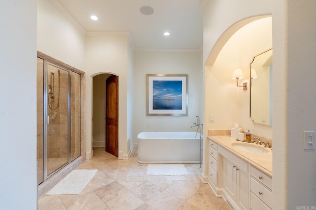 bathroom with baseboards, a stall shower, a soaking tub, and crown molding