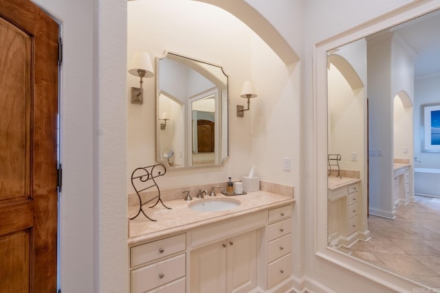 full bathroom with tile patterned flooring, baseboards, and vanity