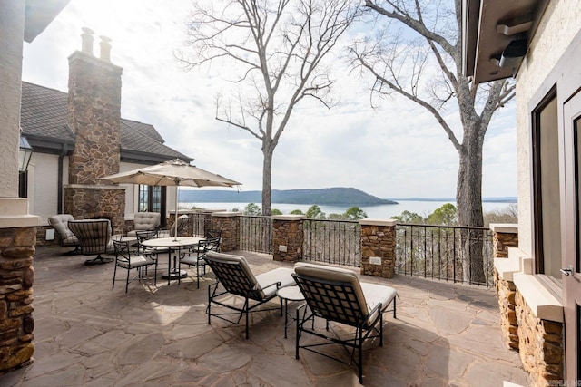 view of patio / terrace featuring a water view and outdoor dining area