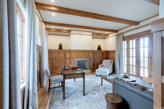 living area featuring recessed lighting, light wood-style flooring, beamed ceiling, and french doors