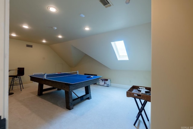 playroom with vaulted ceiling with skylight, carpet, and visible vents