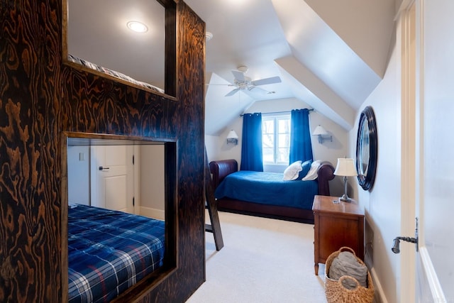 carpeted bedroom with lofted ceiling, ceiling fan, and baseboards