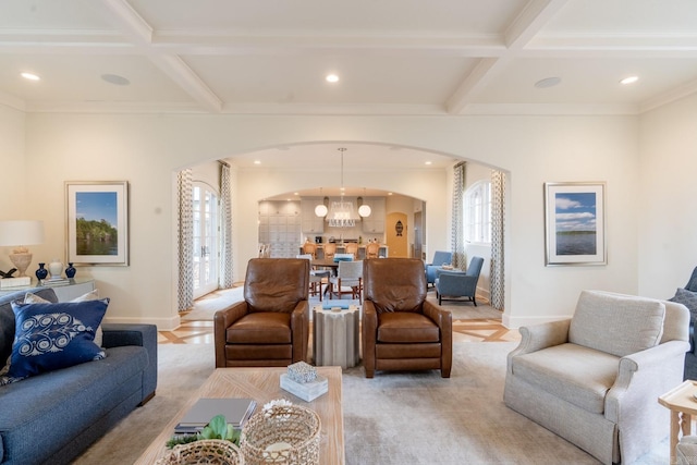 living room with baseboards, arched walkways, coffered ceiling, and beamed ceiling