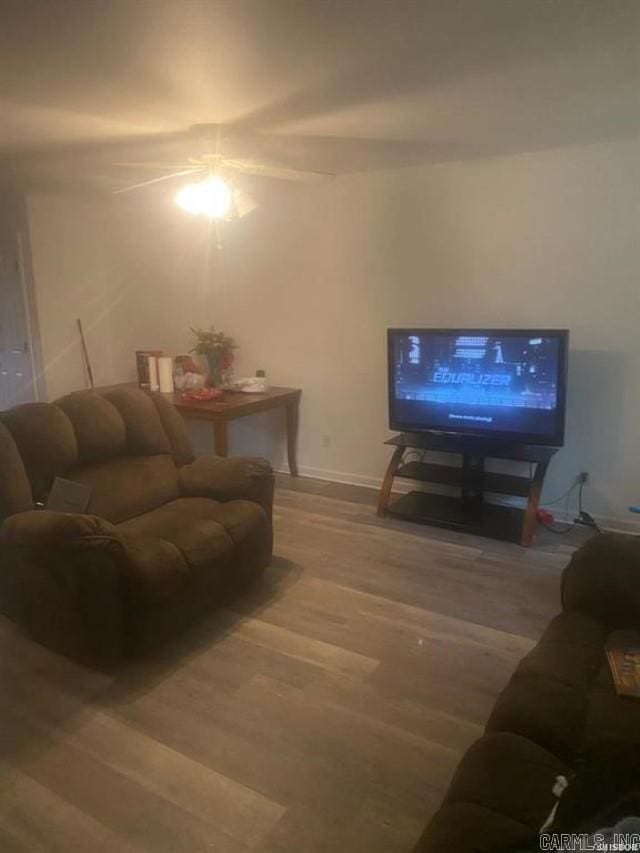 living room featuring baseboards and wood finished floors