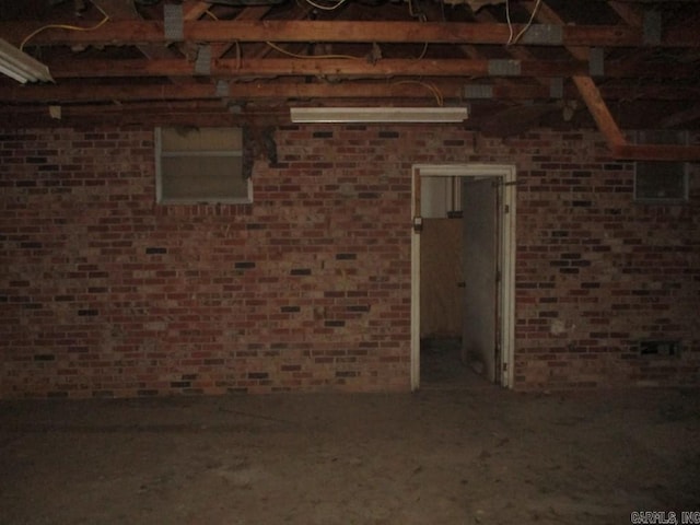 misc room featuring brick wall