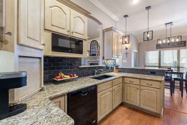 kitchen featuring light wood-style flooring, a sink, ornamental molding, light brown cabinetry, and black appliances