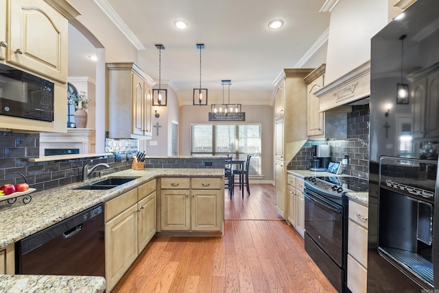 kitchen with light brown cabinets, a sink, black appliances, light wood finished floors, and crown molding