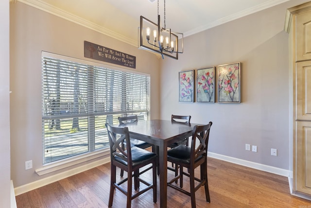 dining space with baseboards, crown molding, light wood finished floors, and an inviting chandelier