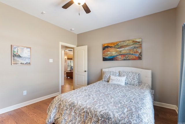 bedroom featuring wood finished floors, a ceiling fan, and baseboards