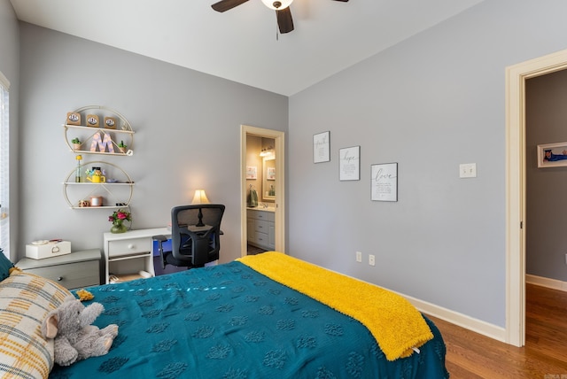 bedroom featuring ceiling fan, ensuite bathroom, wood finished floors, and baseboards