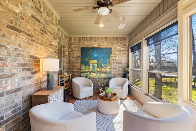 sunroom / solarium featuring wood ceiling, visible vents, and ceiling fan