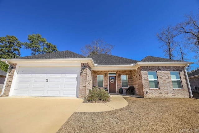 view of front of house with concrete driveway, roof with shingles, brick siding, and an attached garage