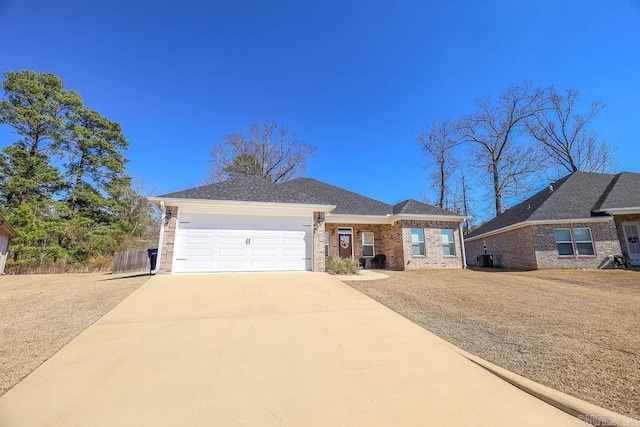 view of front of home with a garage, driveway, and brick siding