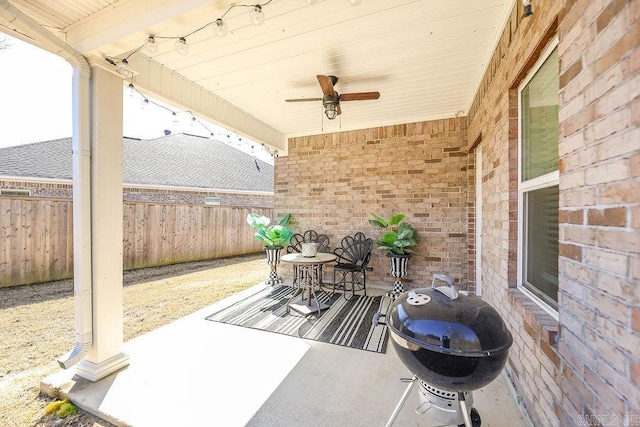 view of patio / terrace featuring ceiling fan, a grill, and fence