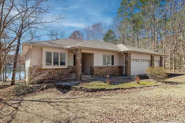 ranch-style house featuring a garage, stone siding, and a shingled roof